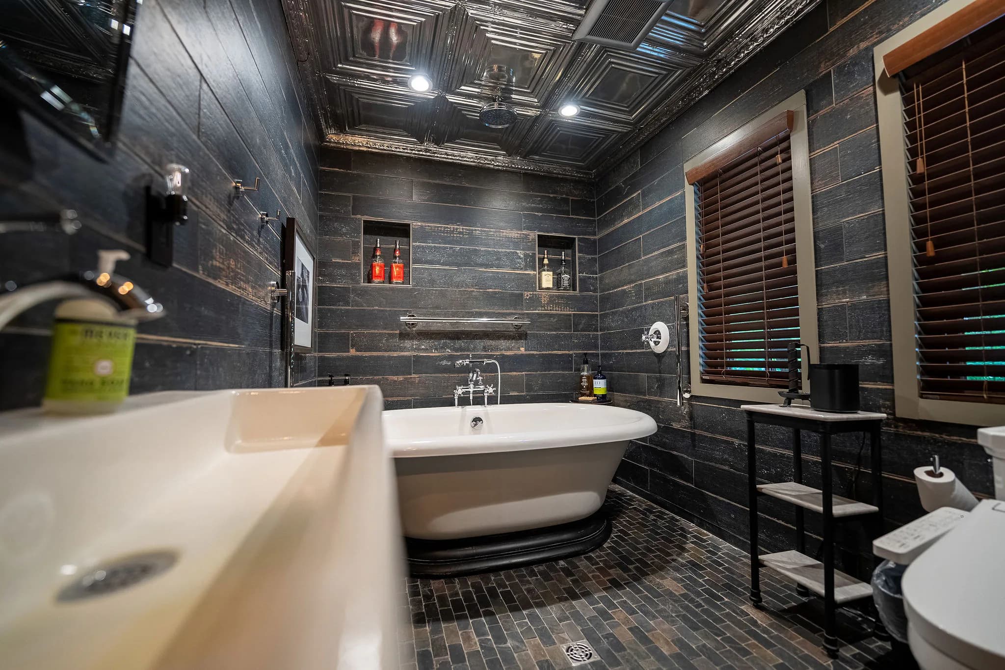 Freestanding soaking tub with black shiplap in a Greenville SC mountain cabin